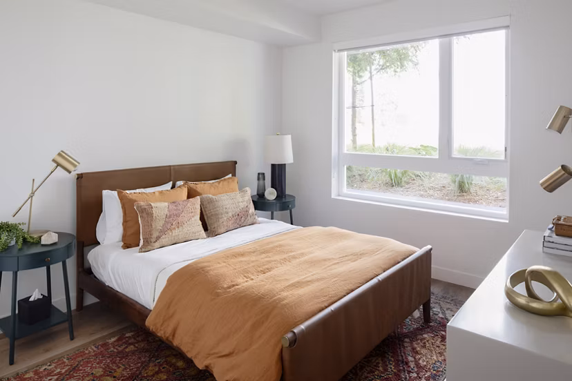 Elegant bedroom with modern furnishings at VOX Apartments in Seattle