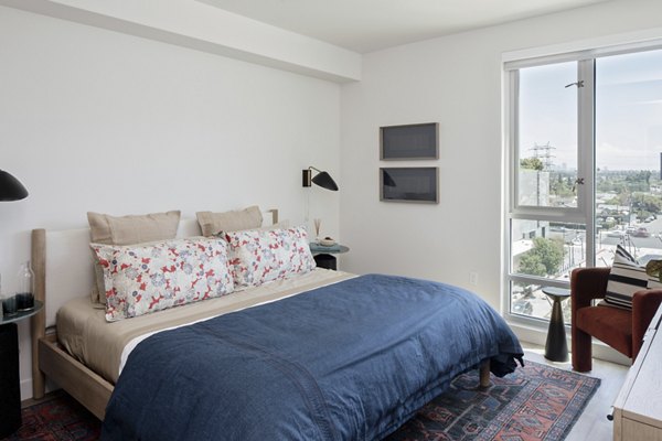 Elegant bedroom with modern furnishings at VOX Apartments in Seattle