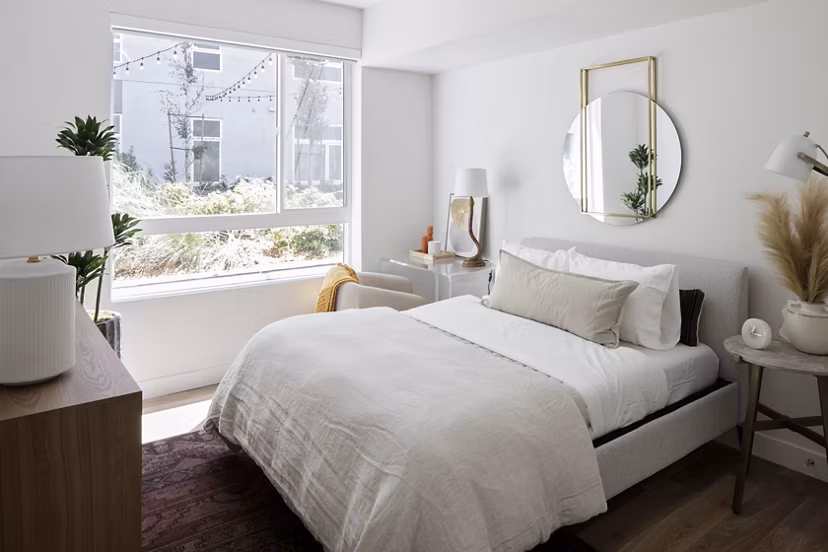 Bedroom featuring contemporary design with plush bedding and modern decor at VOX Apartments