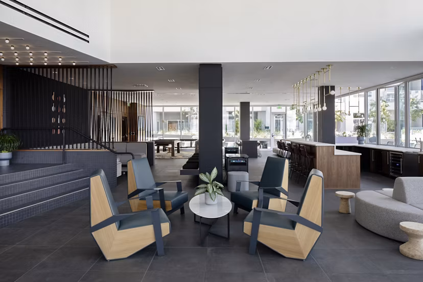 Clubhouse featuring modern design and ample seating at VOX Apartments