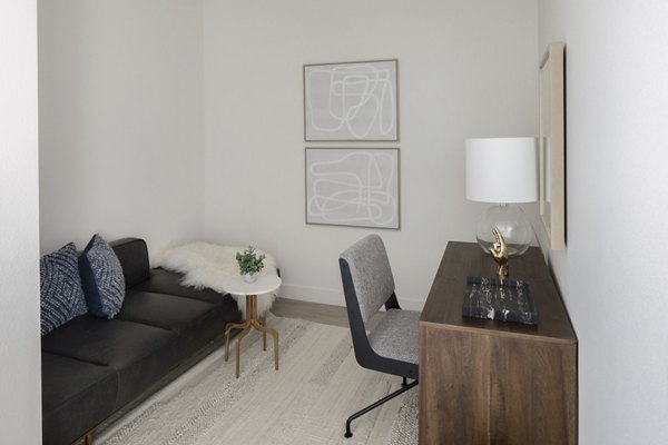 Home office with modern desk and large window at VOX Apartments