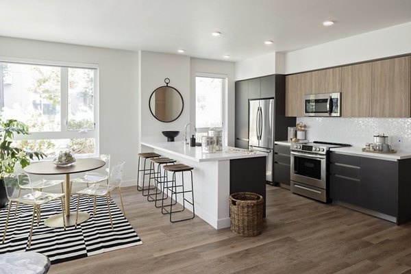 Spacious kitchen with sleek stainless steel appliances at VOX Apartments, featuring modern design and ample counter space