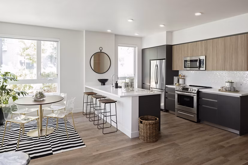 Modern kitchen with stainless steel appliances at VOX Apartments