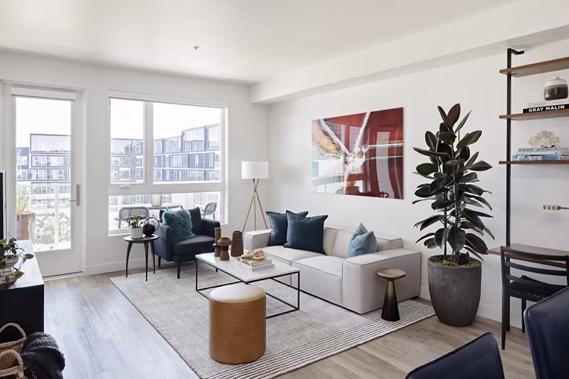 Modern living room with stylish furnishings and large windows in VOX Apartments