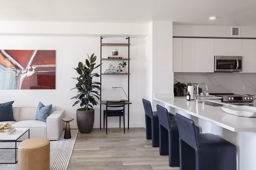 Spacious living room with modern decor and large windows at VOX Apartments in the heart of Greystar luxury communities