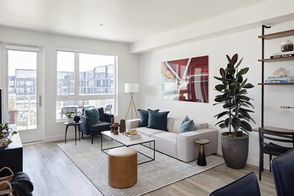 Spacious living room with modern decor and large windows at VOX Apartments in the heart of Greystar luxury communities