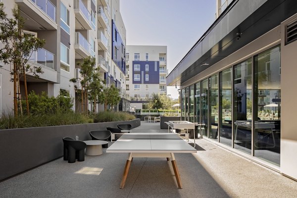 Modern courtyard with seating and landscaped gardens at VOX Apartments