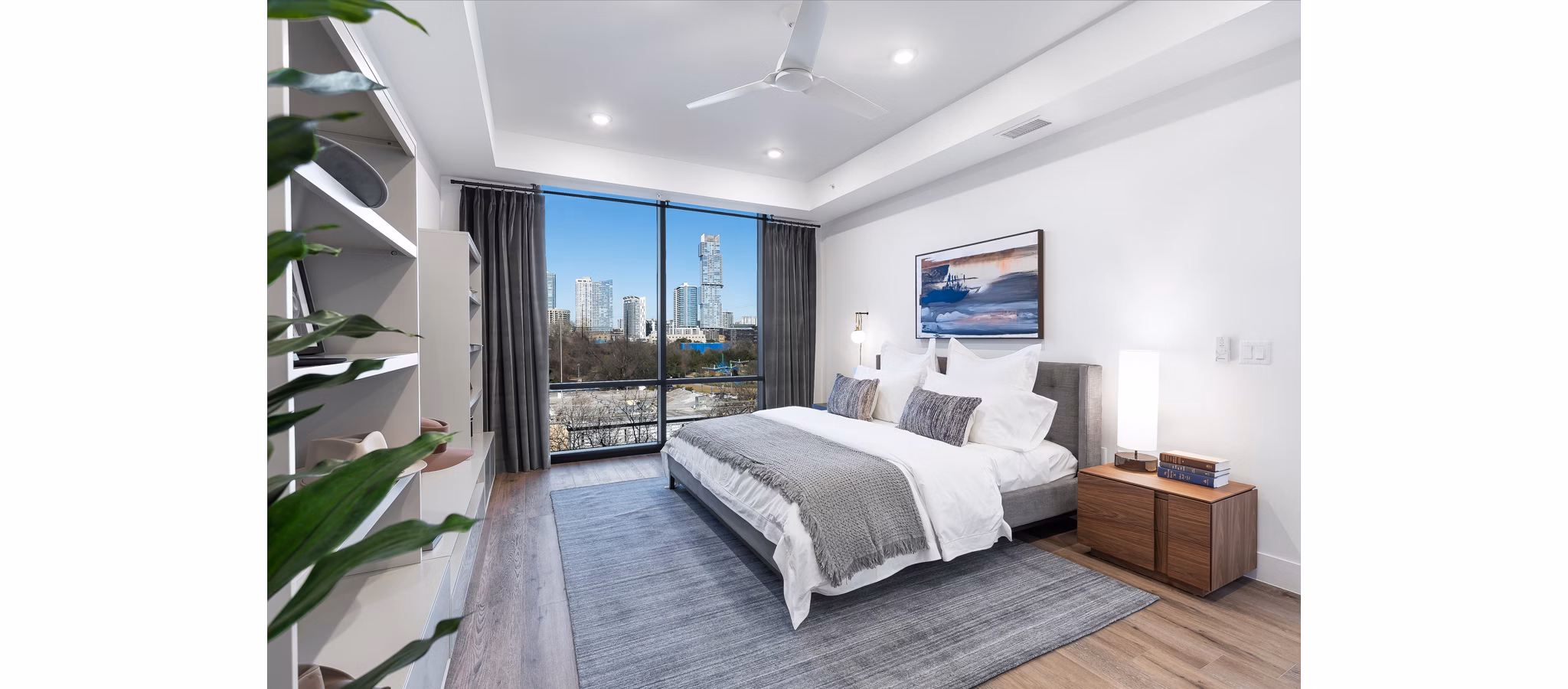 Luxury bedroom with elegant decor at 1155 Barton Springs Apartments, showcasing spacious layout and natural lighting