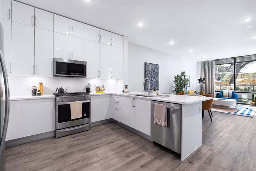 Modern kitchen with stainless steel appliances at 1155 Barton Springs Apartments