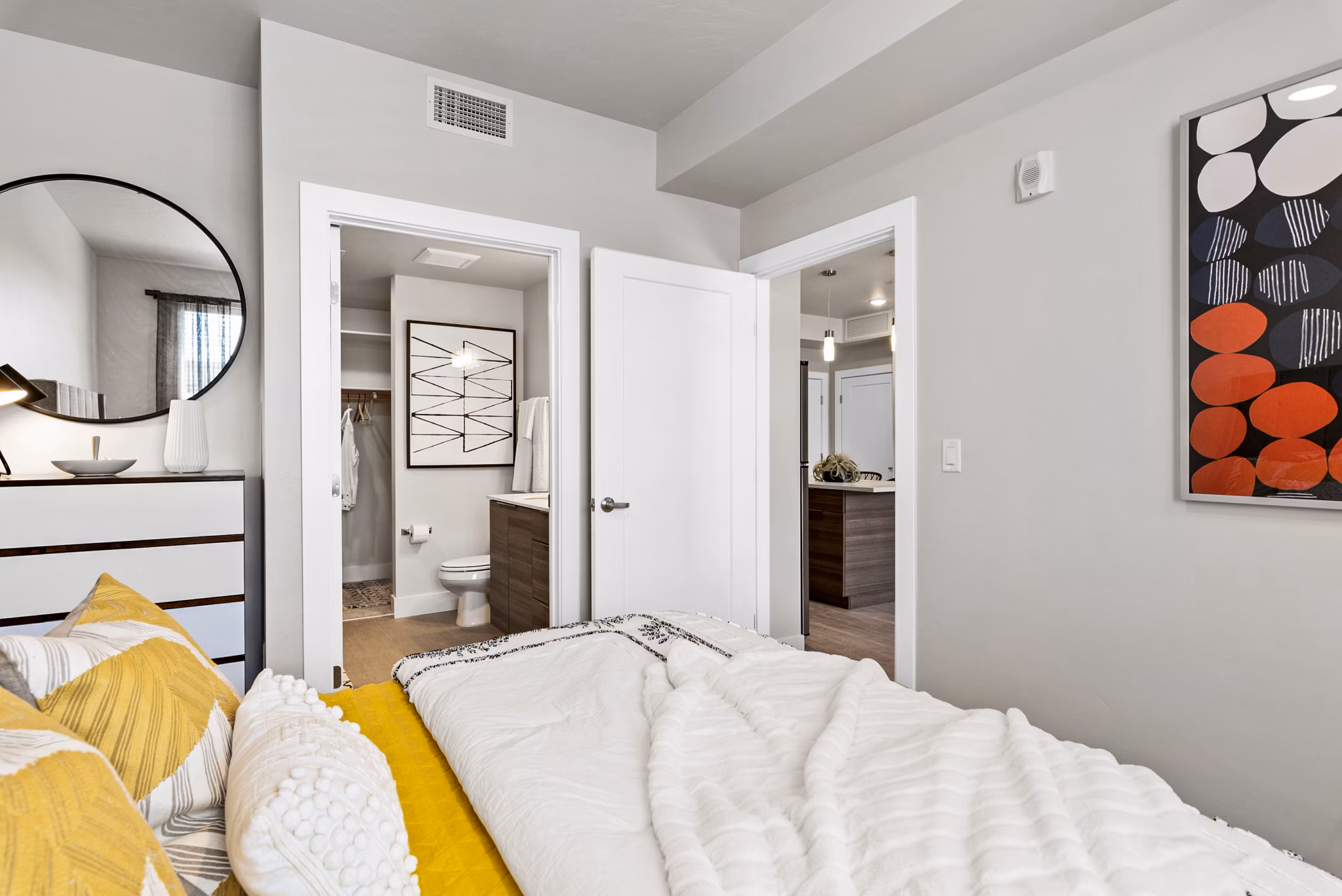 Bedroom with modern furnishings and stylish decor at The Lofts at Ten Mile Apartments