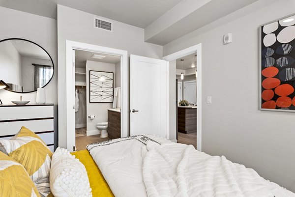 Bedroom with modern furnishings and stylish decor at The Lofts at Ten Mile Apartments