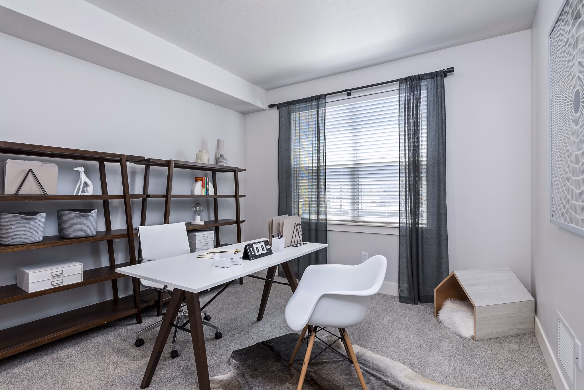 Cozy bedroom/office with natural light at The Lofts at Ten Mile Apartments, perfect for work-from-home comfort and convenience in luxury living