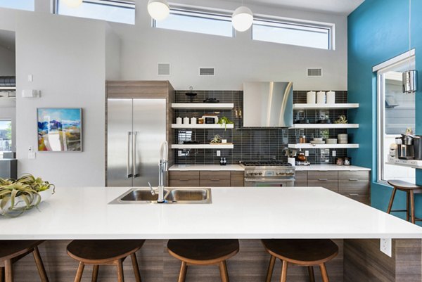 Clubhouse with modern furnishings and social spaces at The Lofts at Ten Mile Apartments in a vibrant community setting