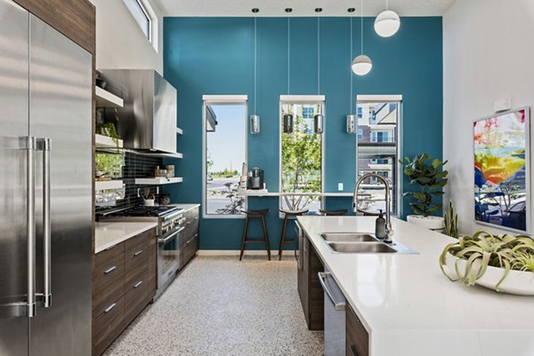 Modern kitchen with sleek appliances in The Lofts at Ten Mile Apartments clubhouse