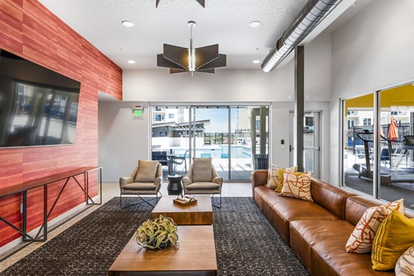 Modern clubhouse at The Lofts at Ten Mile Apartments with comfortable seating and stylish decor