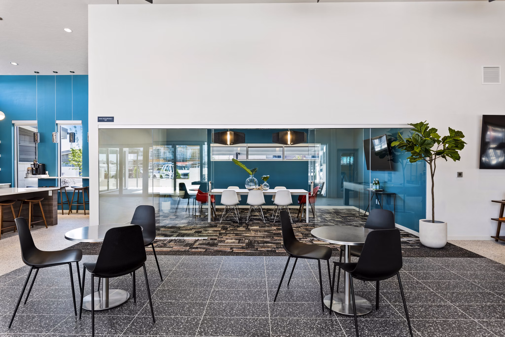 Clubhouse featuring modern design and inviting lounge at The Lofts at Ten Mile Apartments