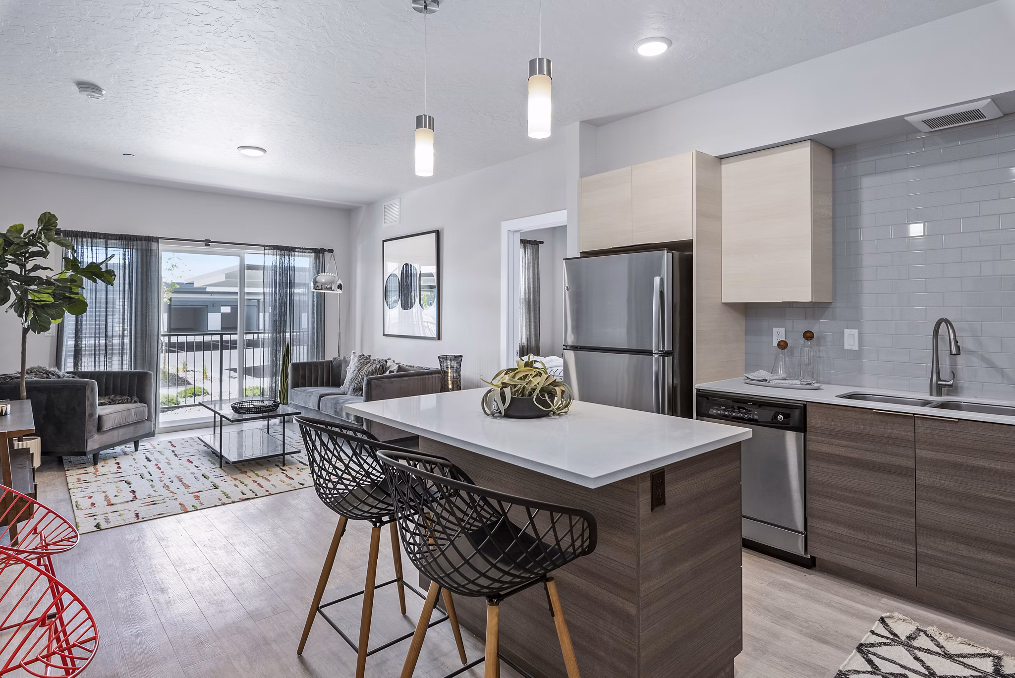Modern kitchen with stainless steel appliances and quartz countertops at The Lofts at Ten Mile Apartments
