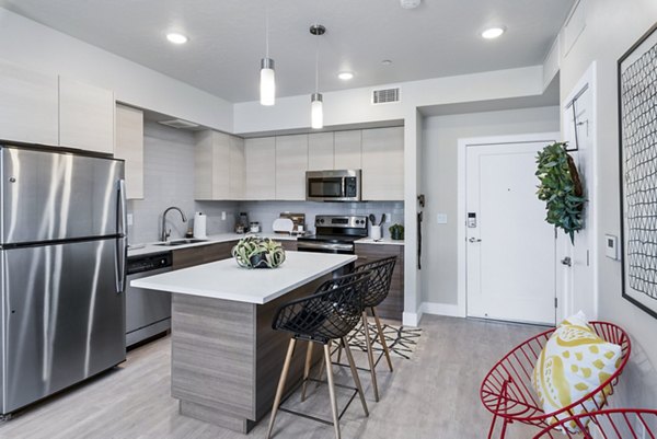 Modern kitchen with stainless steel appliances in The Lofts at Ten Mile Apartments