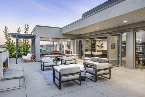 Clubhouse patio with cozy seating and fire pit at The Lofts at Ten Mile Apartments Ideal for socializing and relaxation in a luxury setting