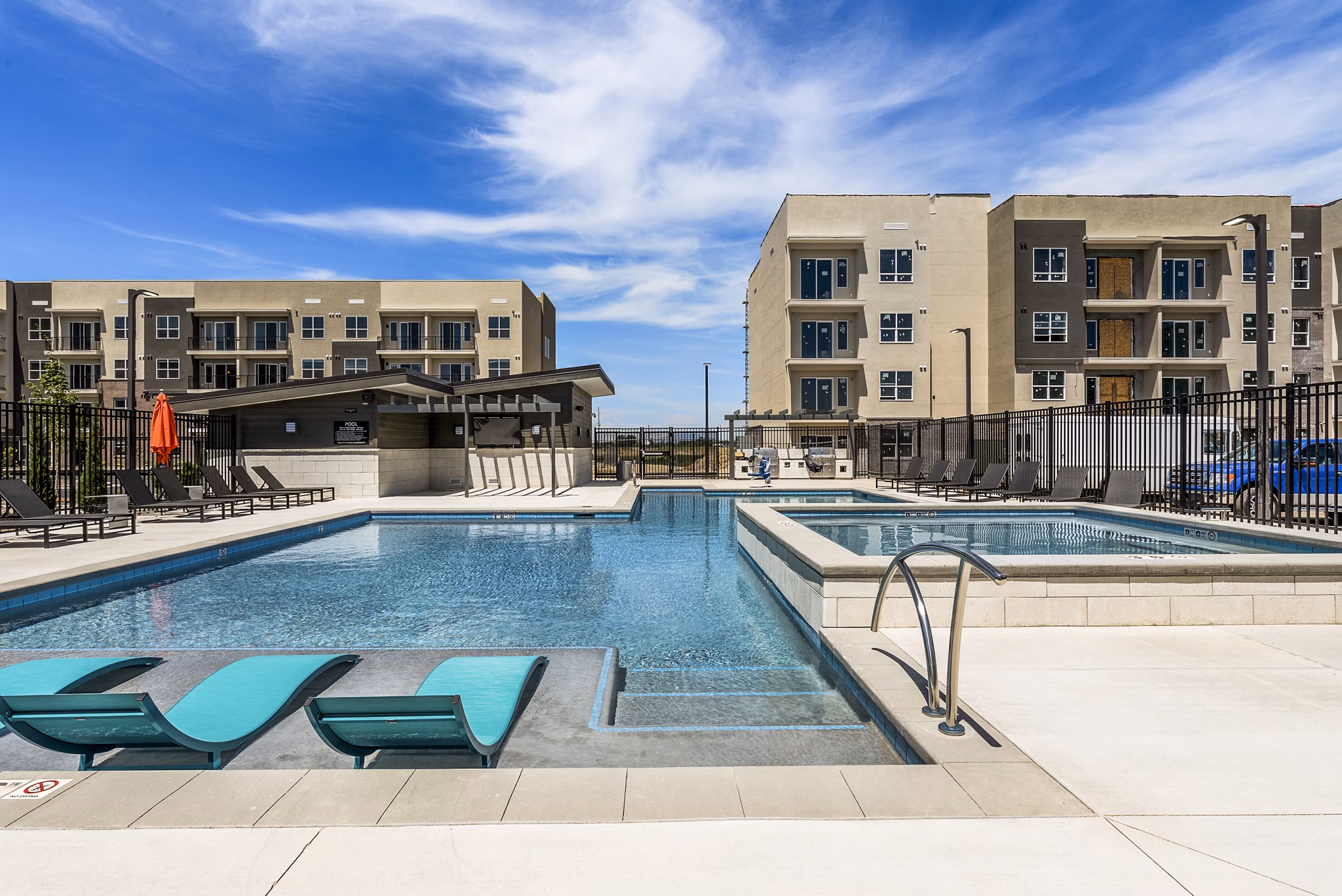 Infinity-edge pool at The Lofts at Ten Mile Apartments offering luxurious leisure experience
