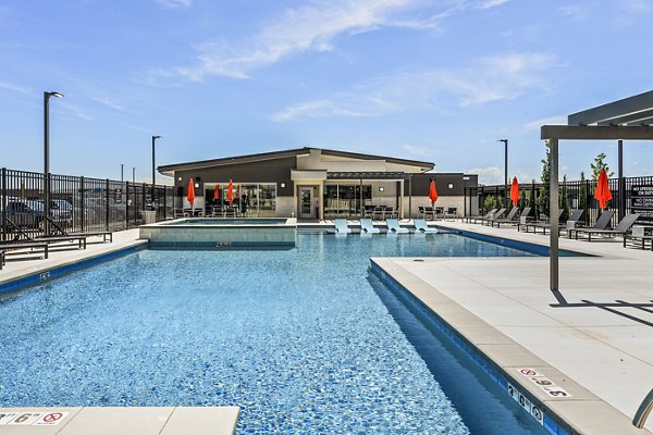 Relaxed poolside seating at The Lofts at Ten Mile Apartments, featuring a modern swimming pool area for residents to enjoy leisure time