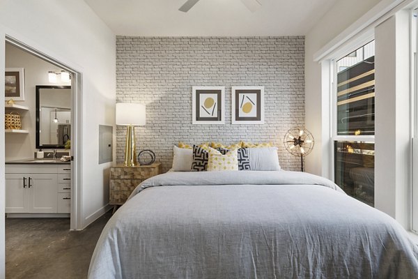 Elegant bedroom with modern decor at Art House Sawyer Yards Apartments, offering luxury living in a vibrant community setting