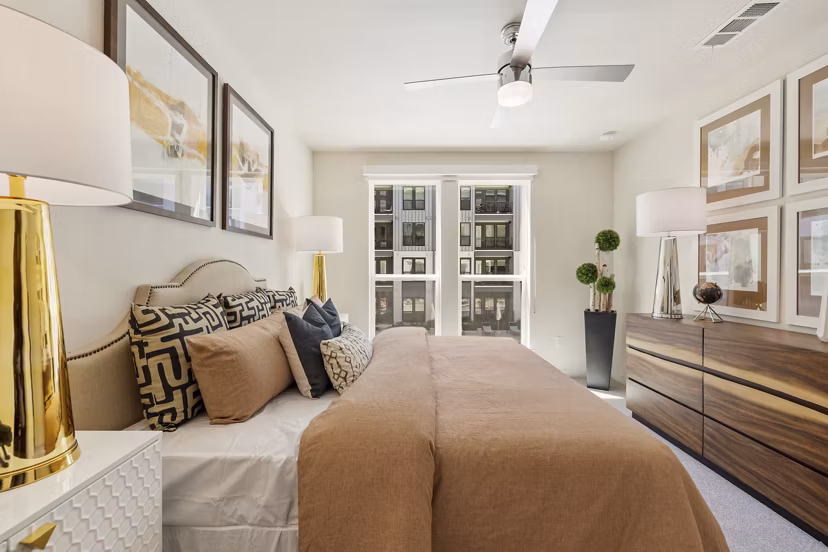 Cozy bedroom with modern decor at Art House Sawyer Yards Apartments in Houston