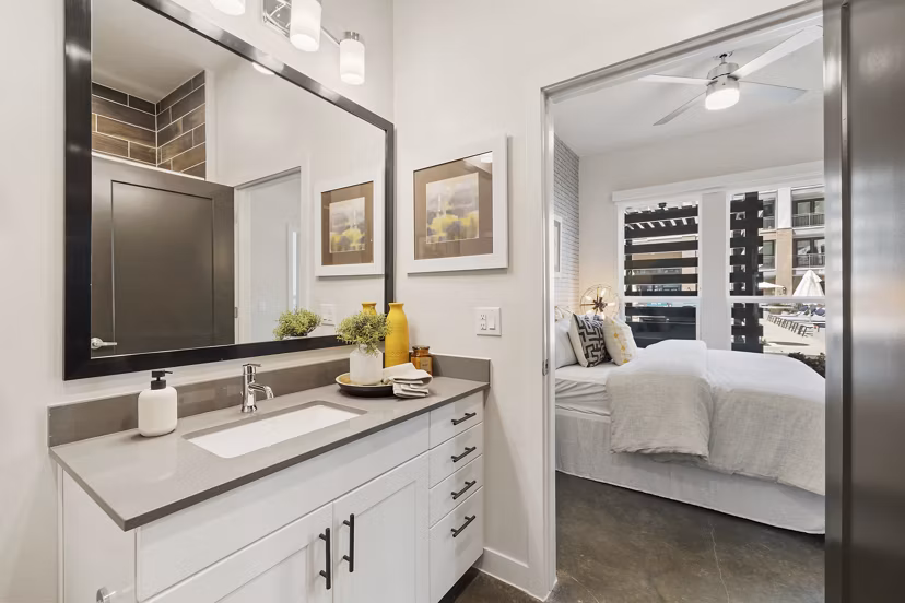 Compact bathroom with sleek fixtures at Art House Sawyer Yards Apartments, offering modern living with premium amenities in a vibrant community
