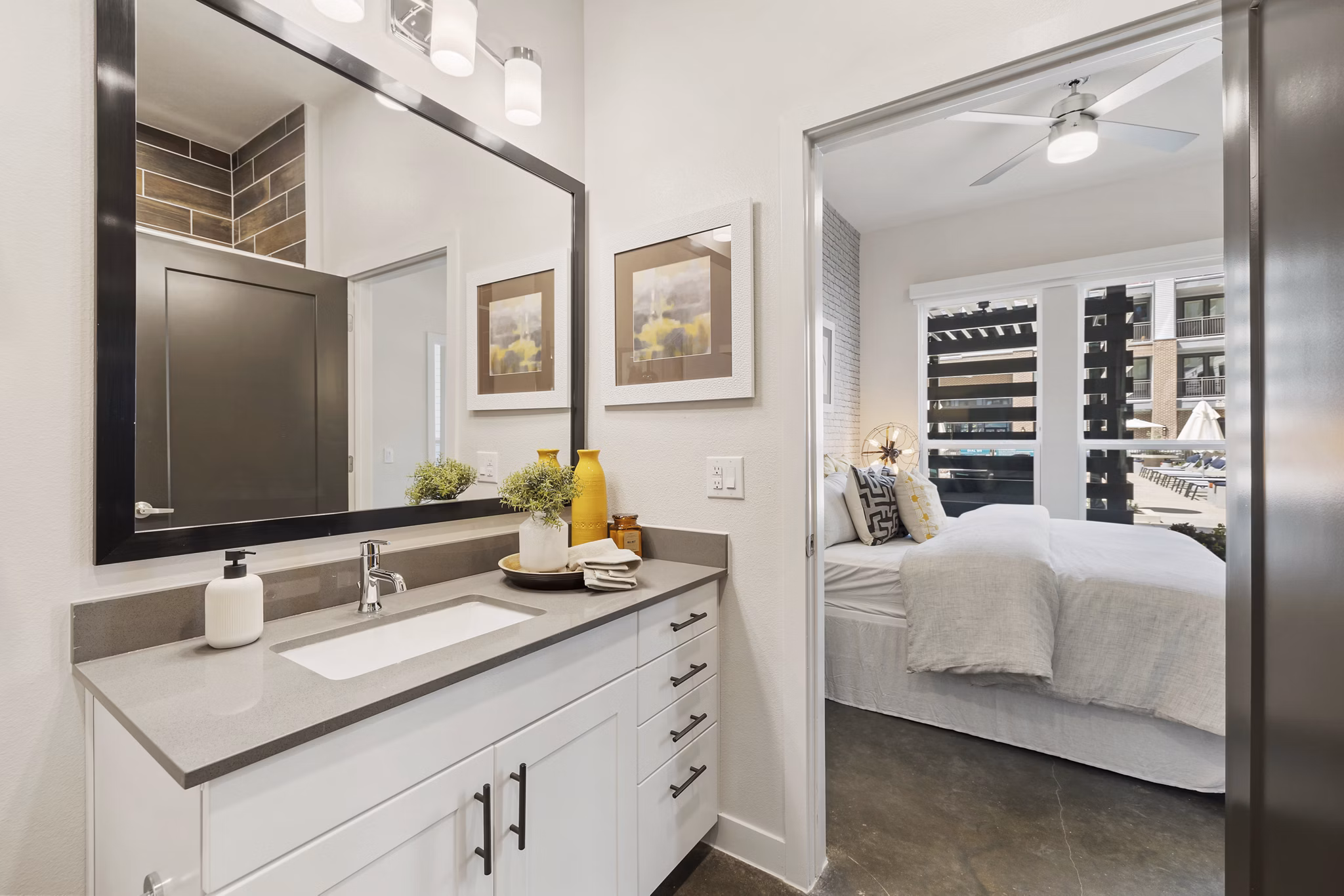 Compact bathroom with sleek fixtures at Art House Sawyer Yards Apartments, offering modern living with premium amenities in a vibrant community
