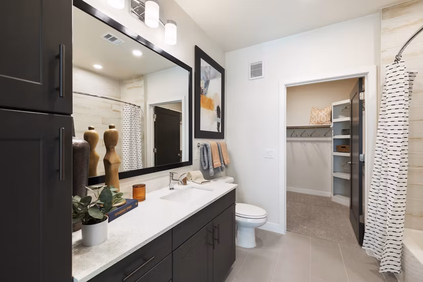 Modern bathroom with sleek fixtures at Art House Sawyer Yards Apartments, featuring elegant tile work and ample lighting for a luxury living experience