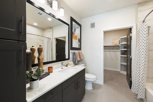 Modern bathroom with sleek fixtures at Art House Sawyer Yards Apartments, featuring elegant tile work and ample lighting for a luxury living experience