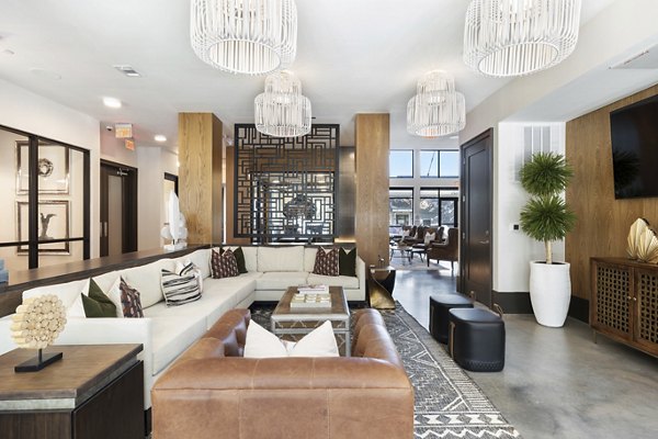 Clubhouse featuring modern design and seating areas at Art House Sawyer Yards Apartments in an urban setting