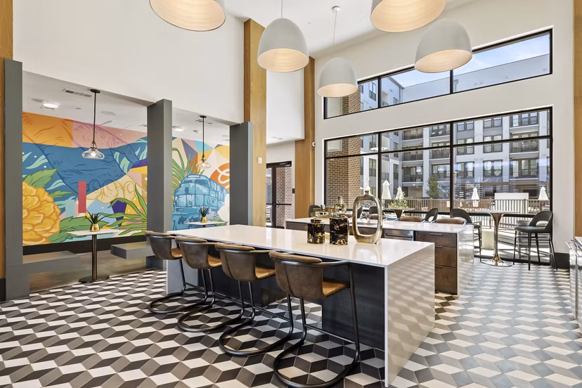 Elegantly designed clubhouse at Art House Sawyer Yards Apartments featuring modern decor and ample seating areas