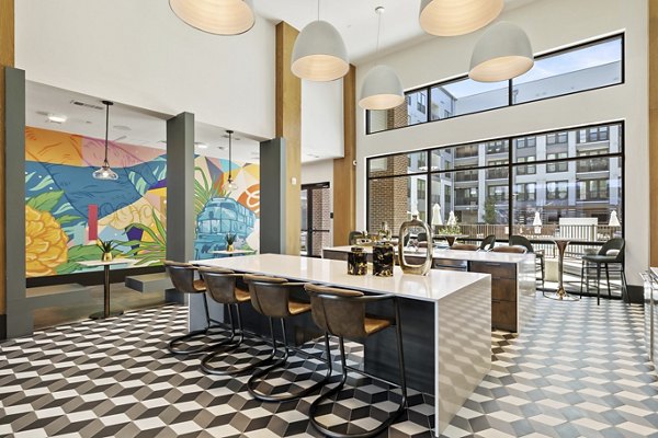 Elegantly designed clubhouse at Art House Sawyer Yards Apartments featuring modern decor and ample seating areas