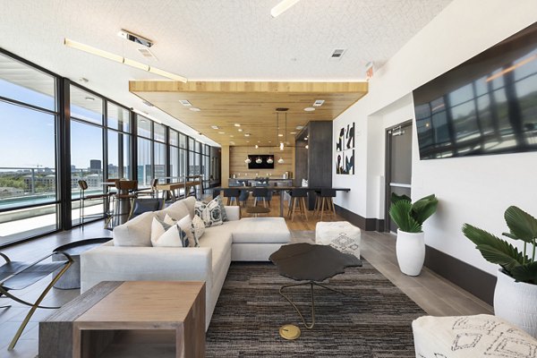 Modern clubhouse with outdoor seating at Art House Sawyer Yards Apartments, perfect for social gatherings and relaxation in Houston