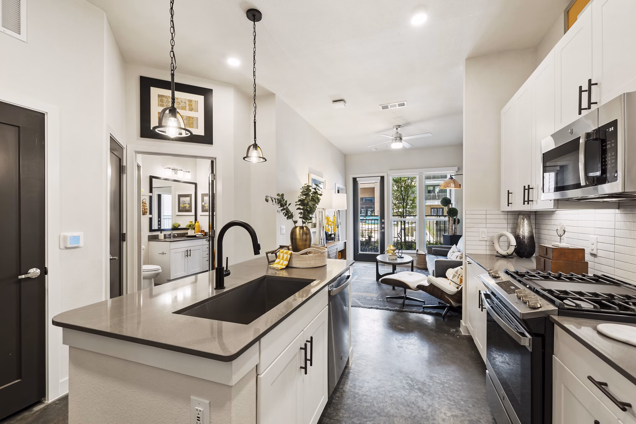 Kitchen featuring modern appliances and sleek countertops in Art House Sawyer Yards Apartments