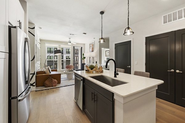 Modern kitchen featuring stainless steel appliances in Art House Sawyer Yards Apartments