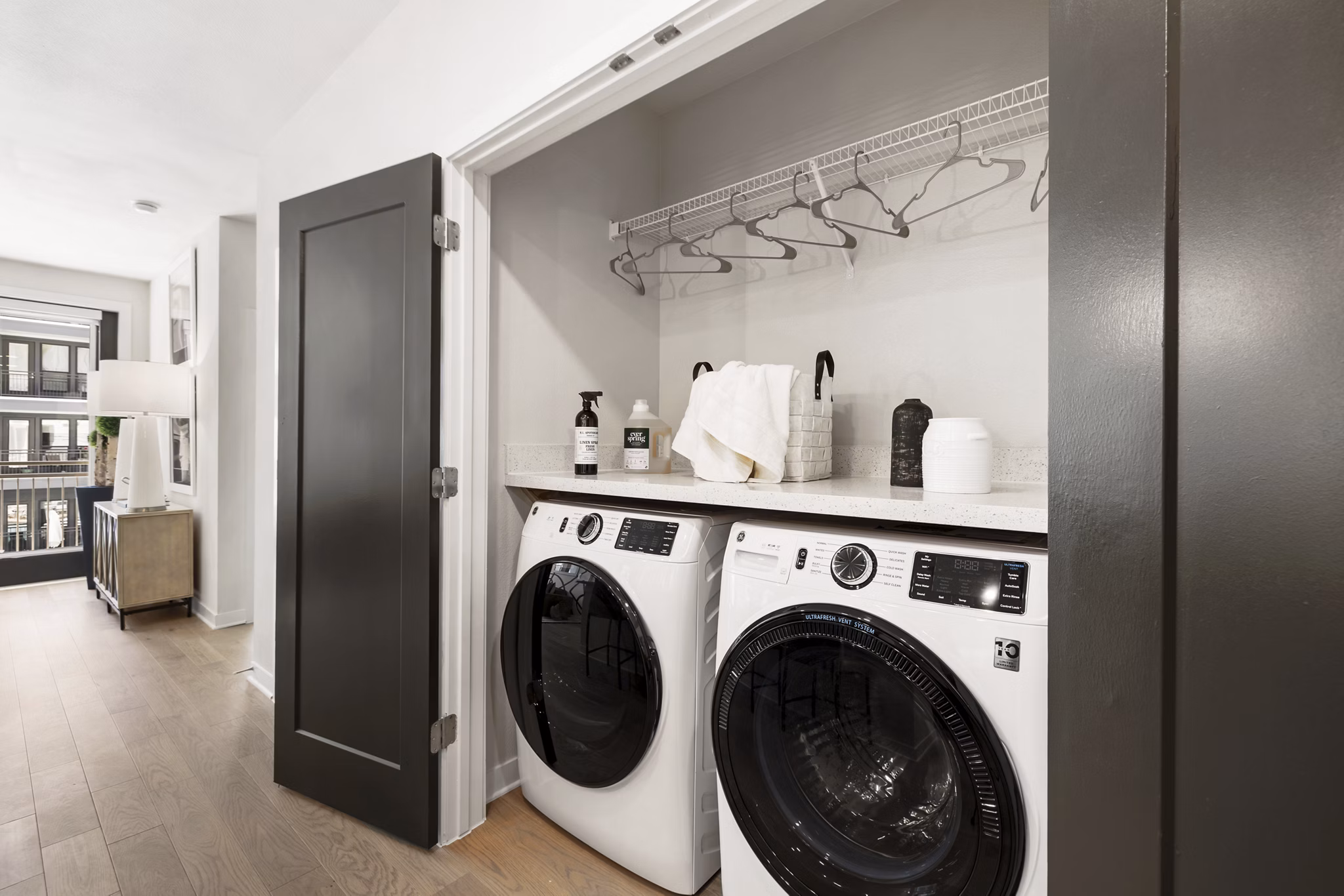 Laundry room with modern appliances at Art House Sawyer Yards Apartments