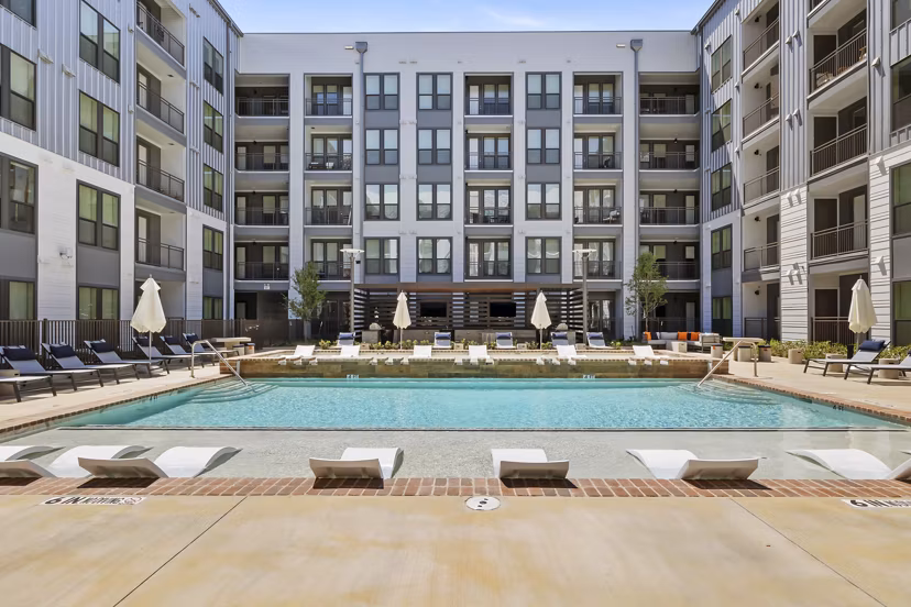 Resort-style pool with sun deck at Art House Sawyer Yards Apartments in Houston, perfect for relaxation and leisure
