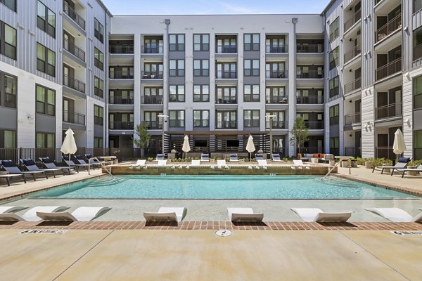 Resort-style pool with sun deck at Art House Sawyer Yards Apartments in Houston, perfect for relaxation and leisure