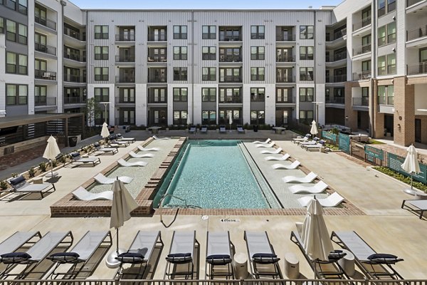 Rooftop swimming pool offering city skyline views at Art House Sawyer Yards Apartments