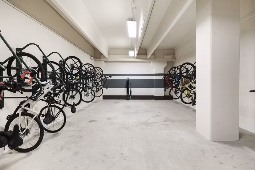 Bike storage area at Art House Sawyer Yards Apartments offers secure racks and efficient space for cyclists in a modern Houston community