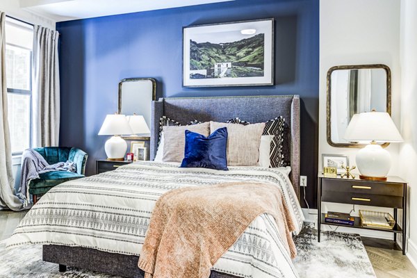 Comfortable bedroom with modern furnishings at The Bowen Apartments
