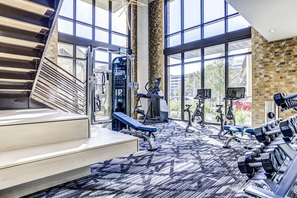 Modern fitness center with state-of-the-art equipment at The Bowen Apartments, offering luxury living by Greystar