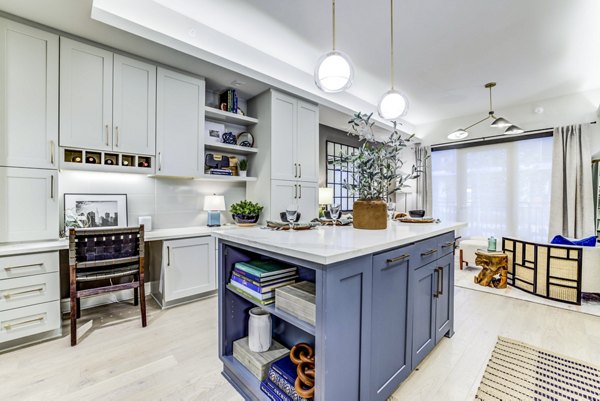 Modern kitchen featuring sleek countertops and stainless steel appliances in The Bowen Apartments
