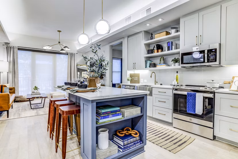 Sleek kitchen with stainless steel appliances in The Bowen Apartments