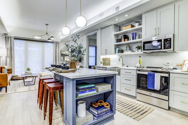 Sleek kitchen with stainless steel appliances in The Bowen Apartments