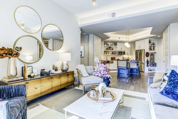Stylish living room with modern furniture and large windows at The Bowen Apartments