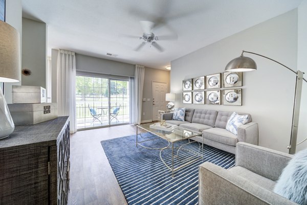 Modern living room with plush seating and large windows at Avana on Broad Apartments, perfect for relaxation and entertaining