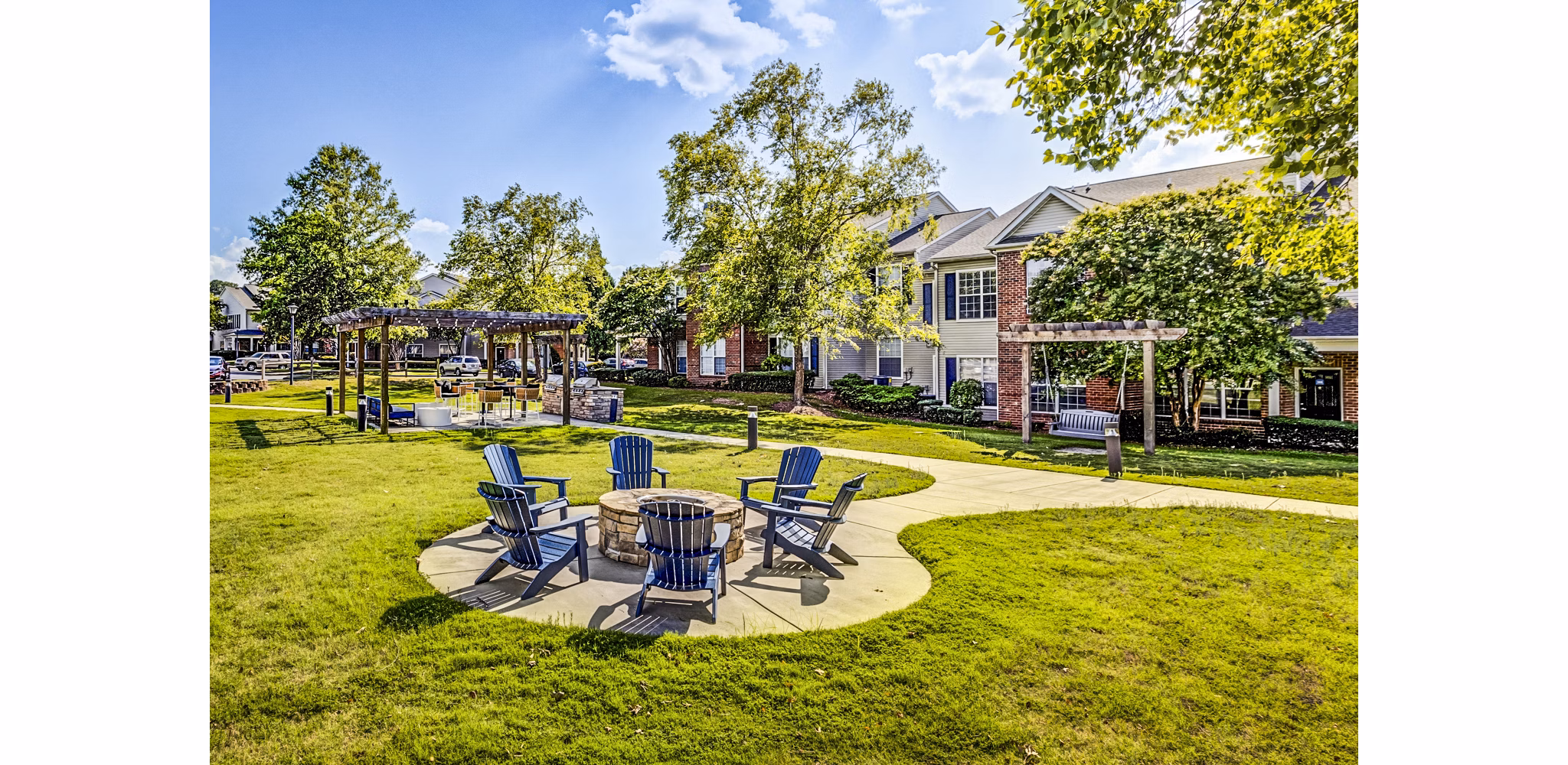 Cozy fire pit lounge area at Avana on Broad Apartments, perfect for relaxing evenings